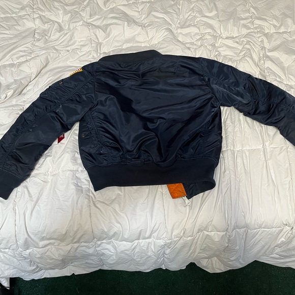 Navy blue bomber jacket With orange inside 
Goes for $300
Flips inside out - Picture 7 of 7